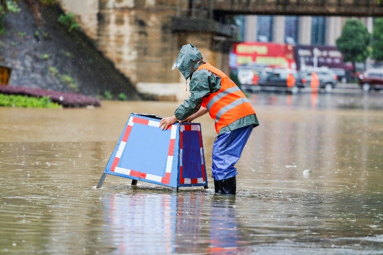 man standing in flooded water